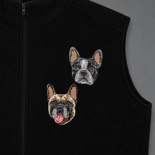 Close-up of two embroidered dog portraits on a black fleece vest