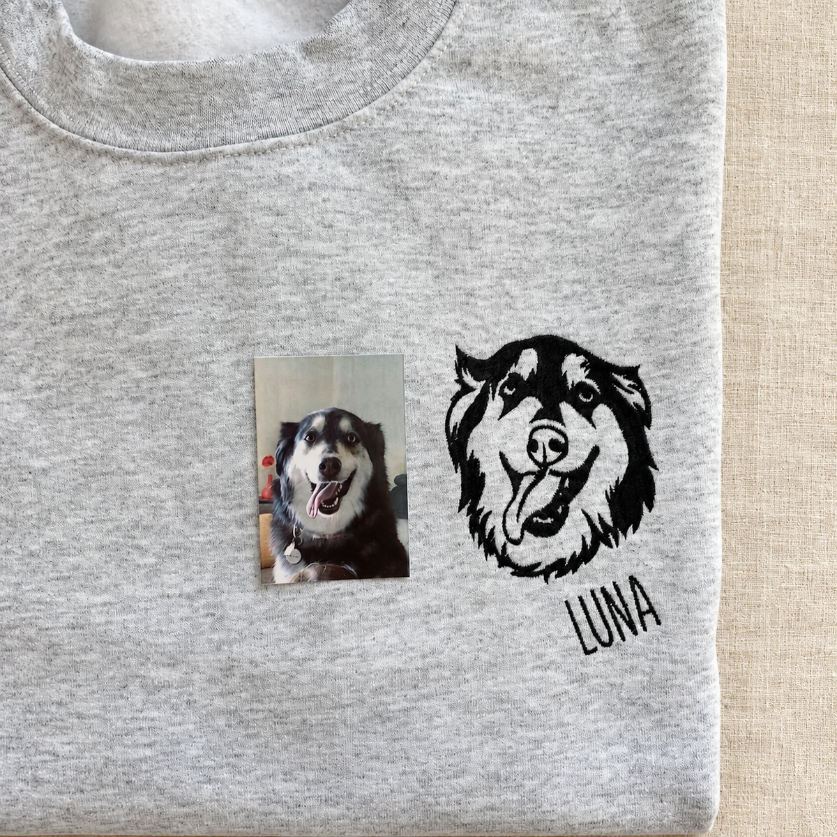 Gray folded shirt with black Luna dog face embroidery and original pet photo