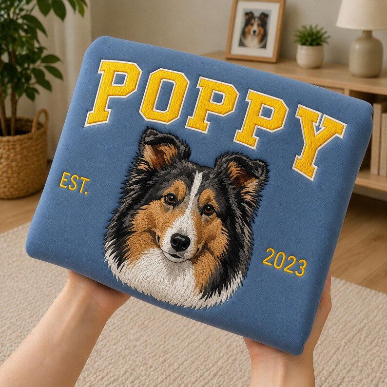 Blue Poppy collie portrait sweatshirt held up in a living room