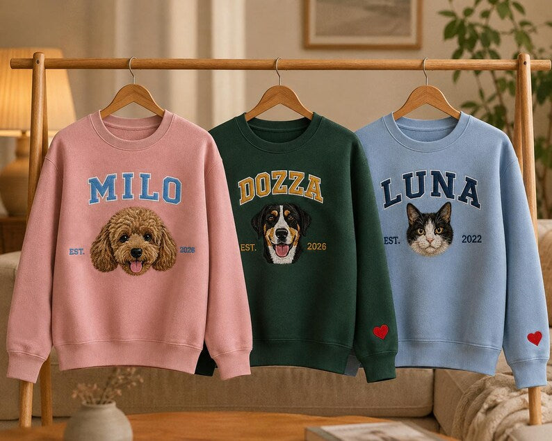 Pink green and blue pet portrait sweatshirts hanging on a rail