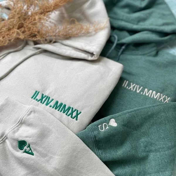 Gray and teal personalized date hoodies with heart and initial sleeve details
