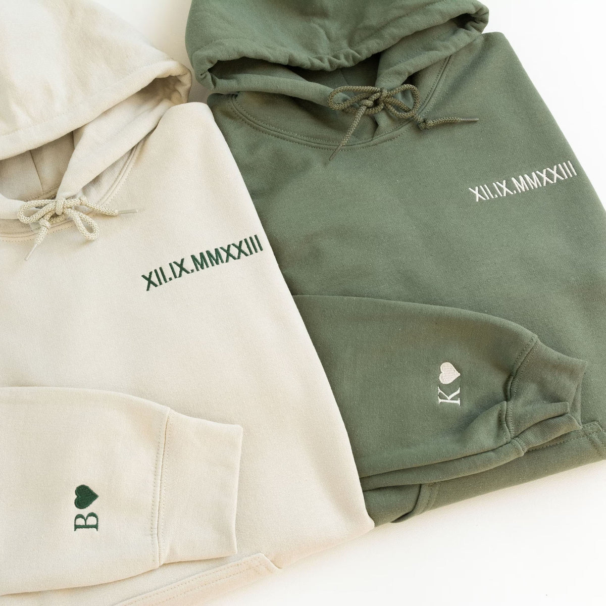 Cream and olive Roman numeral hoodies with embroidered heart cuff details