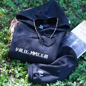 Navy embroidered date hoodie with personalized sleeve initial outdoors