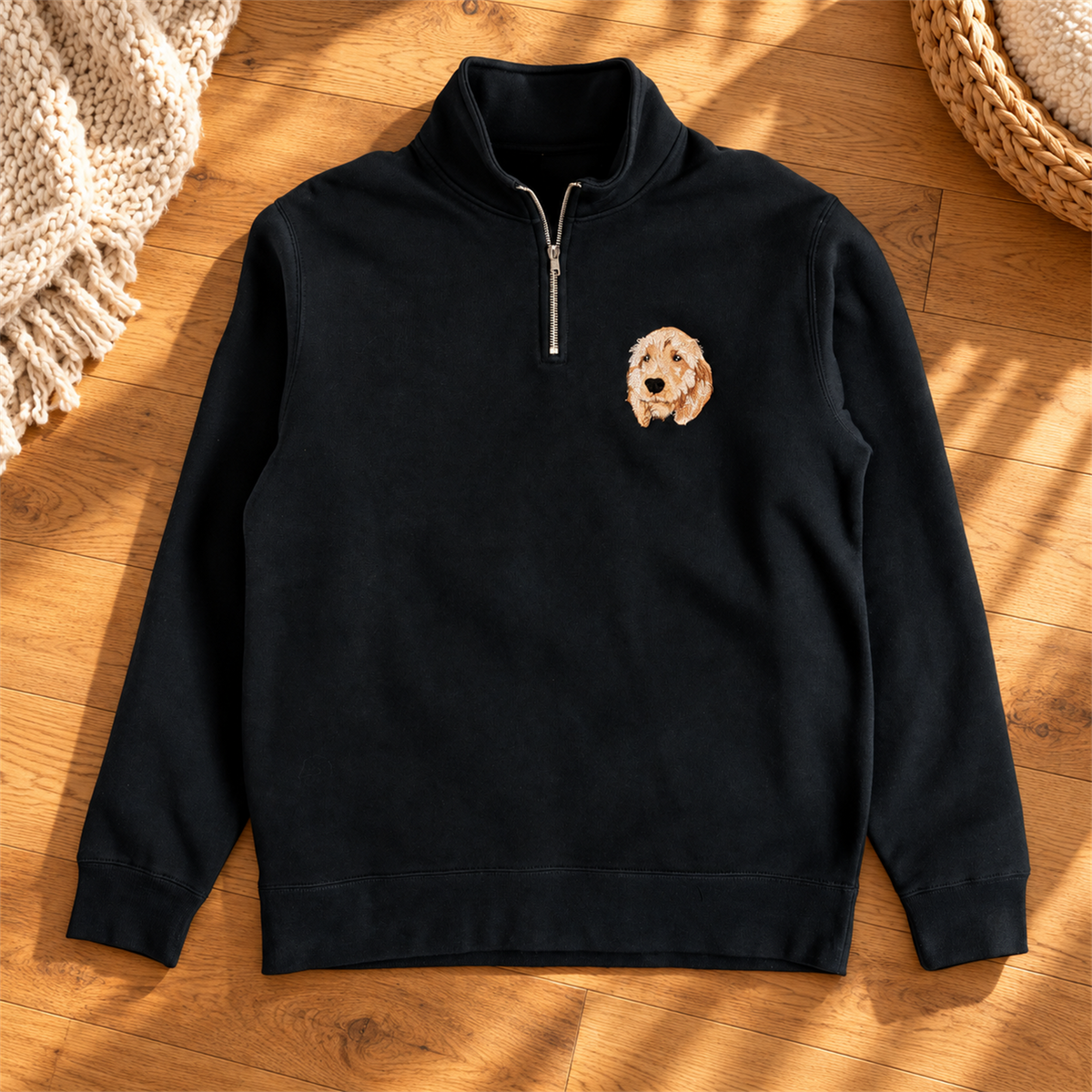 Black quarter zip sweatshirt with colorful dog portrait embroidery in a warm sunlit home setting