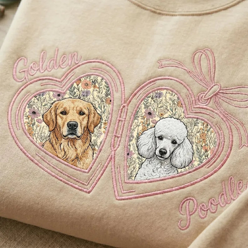 Cream sweatshirt close-up with golden retriever and poodle portraits in pink floral heart lockets