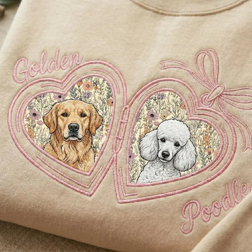 Cream sweatshirt close-up with golden retriever and poodle portraits in pink floral heart lockets
