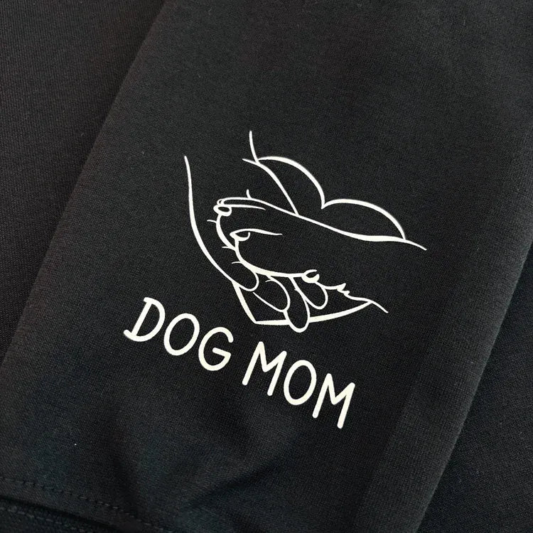 White paw and hand sleeve graphic on black fabric