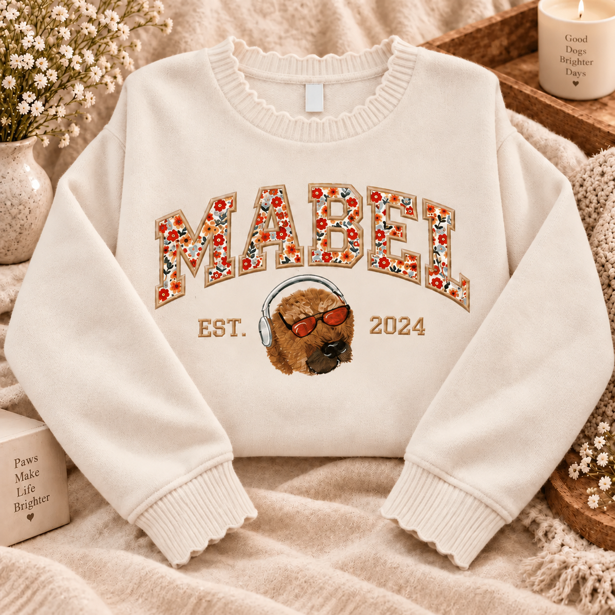 Cream Mabel knit sweater with floral name applique and a dog portrait wearing sunglasses and headphones
