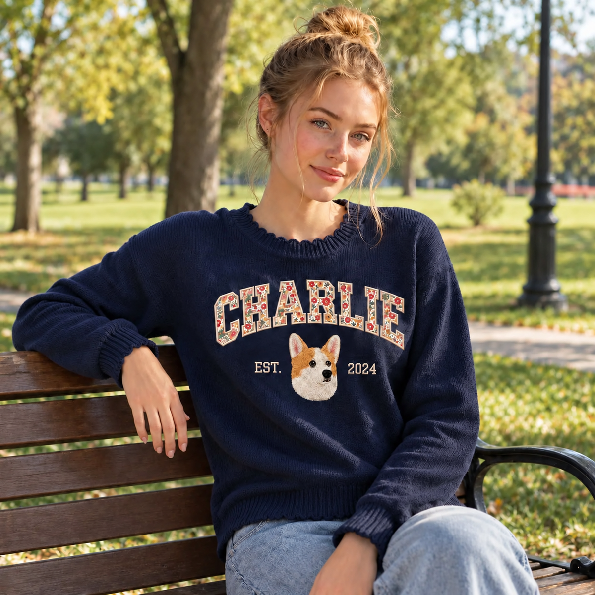 Model wearing navy Charlie corgi portrait knit sweater in a park