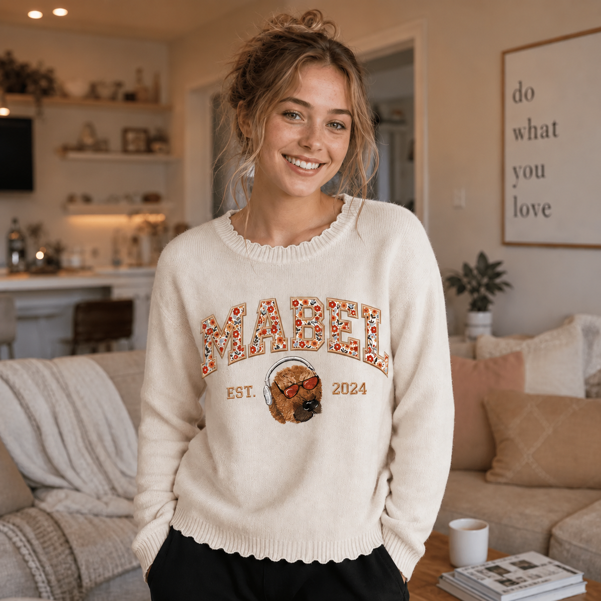 Model wearing cream Mabel dog portrait knit sweater indoors