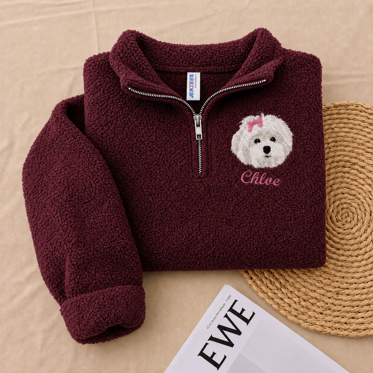 Folded burgundy fleece quarter zip with small white dog portrait and Chloe name