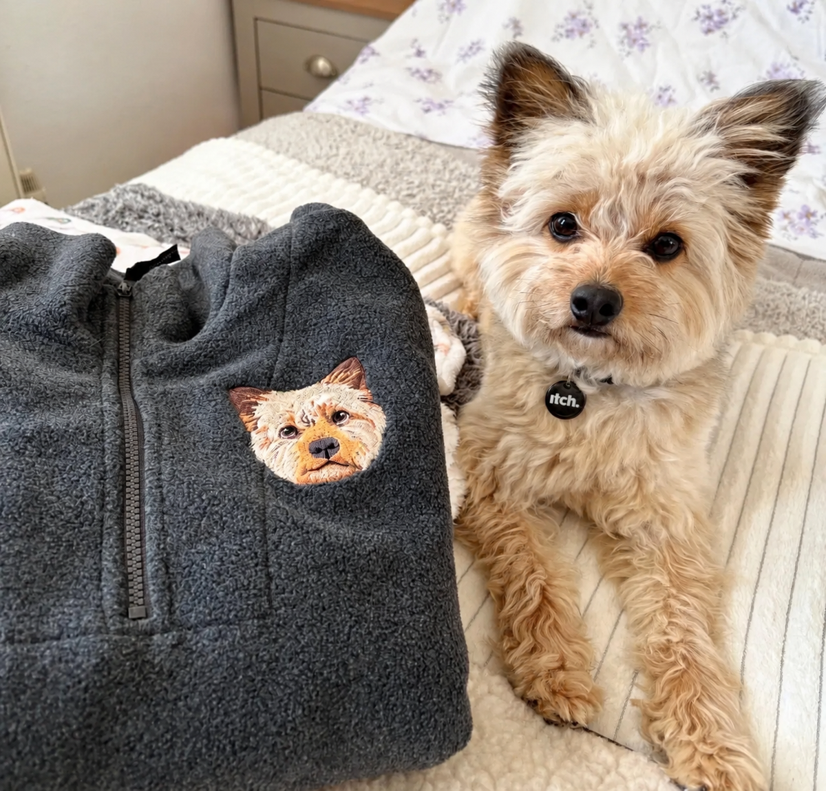 Dark fleece quarter zip with embroidered Yorkshire terrier beside the pet
