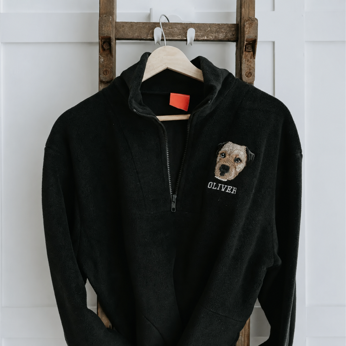 Black fleece quarter zip with dog portrait on left chest
