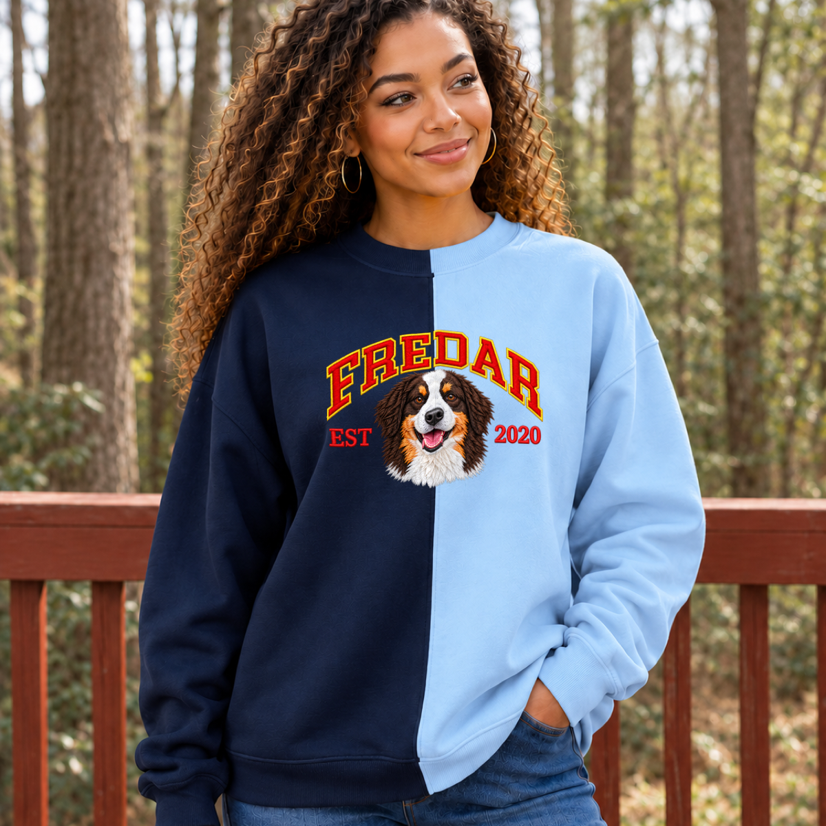 Model wearing navy and light blue split color pet portrait sweatshirt with FREDAR varsity name and EST 2020