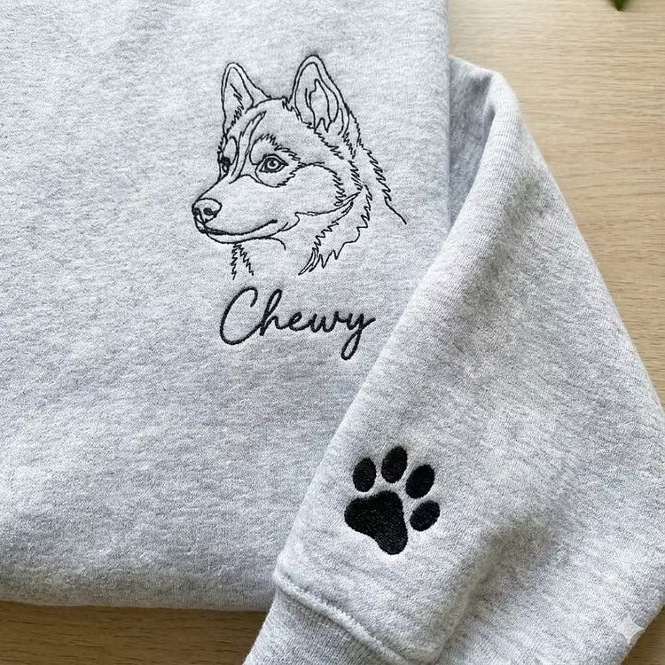Close-up of Chewy husky line embroidery, script name and sleeve paw print