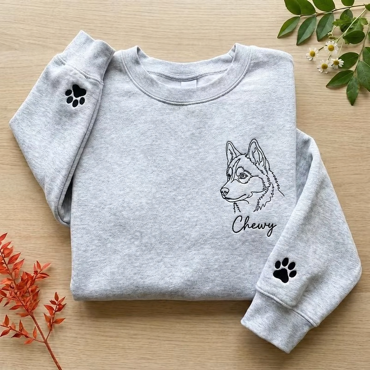 Folded gray Chewy pet outline sweatshirt with paw print details