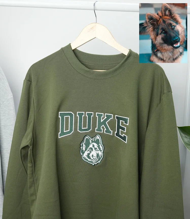 Olive sweatshirt with DUKE in green varsity letters above a German shepherd outline, with the original photo